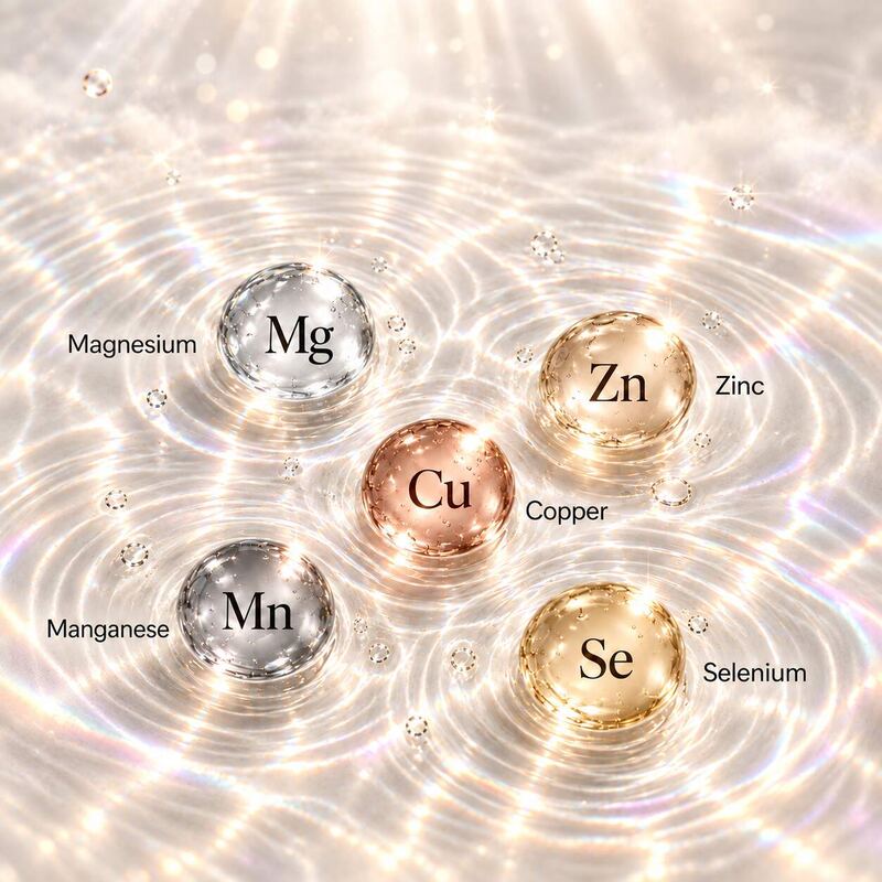 Glass spheres of magnesium, zinc, copper, manganese and selenium resting on sunlit rippling water